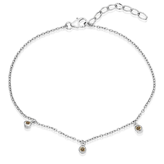 A delicate sterling silver chain bracelet with three evenly spaced champagne cubic zirconia stones and an adjustable extender.